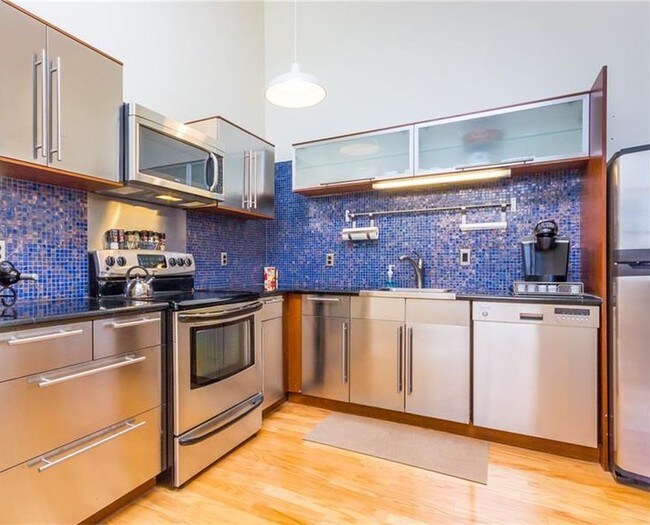 sleek stainless-steel kitchen - 5850 Centre Ave Apartment