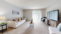 Located at 100 Star Blvd in Nashville, TN, this single-floor, 2-bedroom, 2-bathroom residence offers a practical and comfortable layout. The living room serves as the heart of the home, featuring plush carpeting, neutral gray walls, a textured ceiling, and a large sliding glass door that fills the space with natural light and provides outdoor views. Adjacent to the living area, the dining room offers a cozy setting beneath a classic chandelier, with carpeted flooring and clean, neutral walls. The kitchen is equipped with warm wood cabinetry, light countertops, a double basin sink, and black appliances including a refrigerator and dishwasher, alongside light hardwood-style flooring. The primary bedroom is a well-proportioned retreat with carpeted flooring, soft natural light from dual windows with sheer curtains, and a calm, neutral palette. The second bedroom offers flexibility as a guest room or home office, with a window providing natural light and ample floor space. Both bathrooms feature wood-toned vanities, white countertops, large mirrors, tub-shower combinations, and wood-style flooring. A hallway and closet round out the functional layout of this well-maintained Nashville residence.