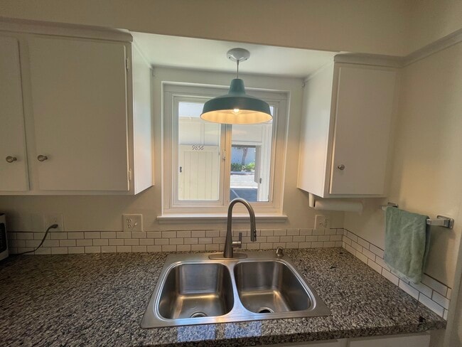 Kitchen sink looking out to backyard and carport - 9856 Continental Dr