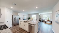 Located at 1157 Ridgeford Dr in Conway, SC, this well-appointed single-story home offers four bedrooms and four bathrooms within a thoughtfully designed open-concept floor plan. The kitchen serves as the heart of the home, showcasing white shaker cabinetry, granite countertops, stainless steel appliances, and a central island with a built-in sink and dishwasher — ideal for both everyday cooking and entertaining. Recessed lighting and durable wood-look flooring carry throughout the main living areas, creating a cohesive and modern aesthetic. The dining area flows seamlessly from the kitchen and features a sliding glass door that fills the space with natural light and provides views of the backyard. The adjacent living room offers a relaxed, open atmosphere with ample space for seating. The primary bedroom is a comfortable retreat, highlighted by a ceiling fan, natural light from multiple windows, and a private en-suite bathroom complete with a dual-sink granite vanity. Three additional bedrooms provide flexible space for guests or a home office. A dedicated laundry room with built-in shelving and a full-size washer and dryer adds everyday convenience. The home's neutral color palette and clean finishes create a bright, welcoming ambiance throughout.