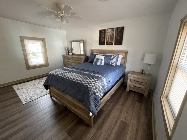 Bedroom with queen bed, dresser, nightstand, and 50" TV - 2312 Old Berwick Rd