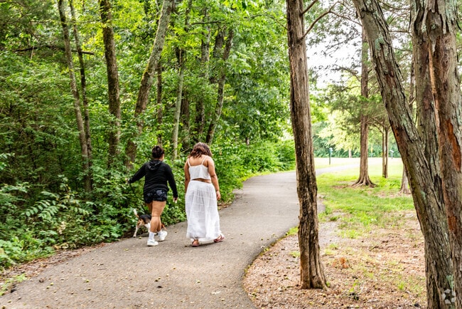 People walking their dog on the greenway at Rosenwald Park in Smyrna.