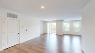 Located at 384 Amwell Rd in Hillsborough, NJ, this contemporary multi-level townhome offers a well-designed layout spread across three floors, providing ample space and clear separation between living and sleeping areas. The entry-level features an attached garage with automatic opener, along with a hallway that leads to a staircase with warm wood treads, white risers, and sleek black metal balusters — a stylish architectural detail that connects all levels. The main living floor is bright and open, featuring wide-plank hardwood-style flooring throughout the living room and kitchen. The living area opens directly onto a private balcony with views of the surrounding community. The kitchen is well-appointed with rich wood cabinetry, granite countertops, subway tile backsplash, stainless steel appliances including a gas range, dishwasher, microwave, and refrigerator, plus a window above the sink for natural light. The upper floor houses both bedrooms, each finished with plush carpet. The spacious primary bedroom includes its own bathroom featuring a granite-topped vanity with dark wood cabinetry and tile flooring. The second bedroom offers dual closets, maximizing storage. Three full bathrooms across the home ensure convenience for residents and guests alike.
