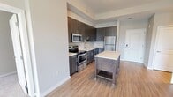 Located at 2827 Telek Pl in Alexandria, VA, this modern 2-bedroom, 2-bathroom residence offers a well-designed single-floor layout with contemporary finishes throughout. The open-concept kitchen is a standout feature, equipped with stainless steel appliances including a range, microwave, and refrigerator, complemented by dark wood cabinetry, light quartz countertops, a tile backsplash, and a freestanding island with built-in shelving. Light wood-style flooring flows throughout the kitchen and living areas, enhancing the bright, airy atmosphere. Large windows in the living area invite an abundance of natural light. Both bedrooms are carpeted and offer a comfortable sense of space, with windows providing views of the surrounding neighborhood. The generously sized primary bedroom is notably spacious and connects to a well-appointed en-suite bathroom featuring a dual-sink vanity with dark wood cabinetry, quartz countertops, a wide backlit mirror, and a sliding glass shower enclosure. The second bathroom offers a clean, modern design with a soaking tub, tiled surround, and a single-sink vanity. Two closets and a hallway complete the layout, providing ample storage. The unit's neutral color palette and modern design elements create a cohesive, move-in-ready aesthetic.