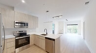 Located at 300 Furnace Street in Emmaus, PA, this contemporary 2-bedroom, 2-bathroom residence offers a thoughtfully designed open-concept layout with modern finishes throughout. The kitchen is a standout feature, showcasing light wood cabinetry, white quartz countertops, a peninsula with an undermount sink and matte black faucet, and a full suite of stainless steel appliances, including a refrigerator, electric range, microwave, and dishwasher. A sleek pendant light anchors the space, which flows seamlessly into the bright living area. Light hardwood-style flooring runs throughout the main living areas, while plush carpet adds comfort to both bedrooms. The primary bedroom is generously sized and connects to a well-appointed bathroom. Each bathroom features light wood floating vanities, white countertops, and a tub-shower combination enclosed by a matte black sliding glass door. Three closets, including walk-in options with wire shelving systems, provide ample storage. A private balcony offers serene views of mature trees and greenery. The unit also includes an in-unit laundry area, recessed and track lighting, and a clean, neutral color palette that creates a bright and welcoming ambiance throughout.
