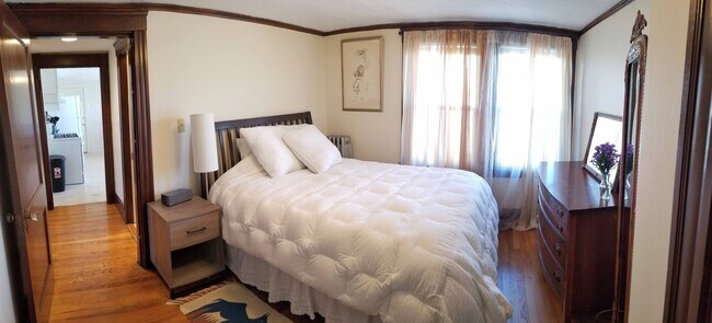 Furnished Bedroom with comfy queen size bed, night stand, lamp, dresser, and full length mirror - 12 Homer St