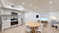 Located in the heart of Los Angeles, this modern 2-bedroom, 3-bathroom residence offers a thoughtfully designed single-floor layout with clean, contemporary finishes throughout. Light wood-style flooring flows seamlessly across the open-concept living and dining area, complemented by crisp white walls and recessed lighting that brighten the entire space.

The kitchen is well-appointed with stainless steel appliances — including a gas range, built-in microwave, dishwasher, and full-size refrigerator — alongside sleek flat-front cabinetry and a classic white subway tile backsplash with white quartz countertops. A round dining table sits just adjacent, creating a natural transition between cooking and entertaining areas.

The living room offers a comfortable, open layout with large roller-shade windows that allow natural light while maintaining privacy. Both bedrooms are generously sized with clean white walls, light flooring, and windows. The primary bedroom provides a calm, restful retreat.

All three bathrooms are finished with hexagonal tile flooring, modern floating vanities featuring white countertops, and tiled shower-tub combinations enclosed by glass sliding doors — delivering a consistently polished aesthetic. A dedicated closet adds practical storage to round out this well-organized residence.