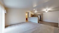 Located at 1340 Pleasant Dr in Plover, Wisconsin, this two-floor residence offers a well-designed layout with practical finishes throughout. The main living area features an open-concept design where a spacious carpeted living room flows directly into the kitchen. The kitchen is equipped with stainless steel appliances — including a refrigerator, range, and microwave — complemented by gray shaker-style cabinetry, granite-look countertops, and wood-look vinyl plank flooring. A peninsula provides additional counter space and casual seating potential.

The bedrooms are carpeted and generously sized, offering natural light through large windows with blinds and baseboard heating for comfort. The bathrooms feature wood-look vinyl plank flooring, taupe cabinetry with granite-look countertops, and brushed nickel hardware. One bathroom includes a walk-in shower, while another provides additional functionality for daily use.

A dedicated in-unit laundry area comes equipped with a full-size washer and dryer alongside wire shelving for storage. The attached garage offers ample room for vehicle parking and additional storage. Carpeted stairs with a white handrail connect the two floors, completing this practical and comfortable Plover residence.