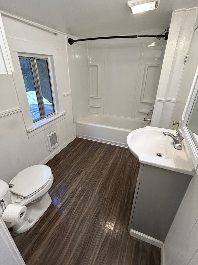 Remodeled bathroom with new wall heater. Building has all new plumbing including new water and sewer - 4510 Dunsmuir Ave