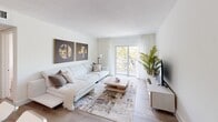 Located at 4335 NW 18th St in Miami, FL, this efficiently designed one-bedroom, one-bathroom residence offers a thoughtfully curated layout across a single floor. The open-concept living and kitchen area serves as the heart of the home, where light wood-style flooring, neutral tones, and a large sliding glass door with sheer curtains create a bright, airy atmosphere with lush outdoor views. The living space comfortably accommodates a sectional sofa, coffee table, and entertainment setup, accented by decorative artwork that adds a contemporary flair.

The kitchen features crisp white cabinetry, granite countertops, stainless steel appliances, a tile backsplash, and a peninsula with bar seating — ideal for casual dining or meal prep. Recessed lighting enhances the clean, modern aesthetic.

The bedroom is a serene retreat with warm wood flooring, a natural light-filled window, a dedicated closet, and ample space for a full bedroom set. A hallway connects the main living areas, providing a smooth and functional flow throughout the unit.

The bathroom stands out with floor-to-ceiling marble-style tile, a walk-in shower with hexagonal mosaic tile flooring, and a sleek, minimalist design that elevates the overall sense of luxury. This well-appointed Miami residence blends style, comfort, and practicality.