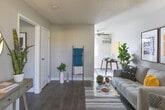 Located at 1900 S Campus Ave in Ontario, California, this single-floor residence offers a thoughtfully designed layout that balances comfort and modern style. The living area is bright and welcoming, featuring wood-style flooring, neutral walls, and natural light that flows in through large windows dressed with sheer curtains. A ceiling fan adds to the comfort of the space, which flows seamlessly into a dining area.

The kitchen is efficiently designed with crisp white shaker-style cabinetry, gray countertops, and a full suite of stainless steel appliances including a gas range, over-the-range microwave, and refrigerator. The clean, contemporary aesthetic makes it both functional and visually appealing.

The bedroom is a calm retreat, showcasing wood-style flooring, a textured ceiling, and an open closet with built-in shelving and hanging space. The room offers ample storage and connects conveniently to the bathroom. The bathroom features a shower-tub combination, a window for natural light and ventilation, and clean white fixtures throughout.

The overall ambiance of the space is modern and cohesive, with a neutral color palette accented by warm wood tones. The single-floor layout ensures easy accessibility and a comfortable flow between all areas of the home.