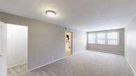 Located at 950 Village Green Ln in Waterford, Michigan, this single-floor residence features 4 bedrooms and 2 bathrooms within a thoughtfully arranged layout. The living area is generously sized, finished with plush carpeting, neutral gray walls, and a large window that allows natural light to fill the space. A flush ceiling light fixture adds a clean, practical touch, while an open doorway connects seamlessly to the kitchen. The kitchen is efficiently designed with warm wood-toned cabinetry, laminate countertops, a single-basin sink, a dishwasher, a full-size refrigerator, and a microwave set within a wall-mounted cabinet, all over easy-care hardwood-style flooring. The spacious primary bedroom features soft carpeting, warm neutral tones, and windows that bring in outdoor views. Additional bedrooms are well-proportioned, with some featuring hardwood-style flooring and windows overlooking the exterior. The two bathrooms are cleanly finished — one features a full soaking tub with a shower, curved curtain rod, and tiled flooring, while the other includes a vanity with a marble-patterned countertop and a medicine cabinet. A hallway and closet round out the practical layout, making this a comfortable and functional home.
