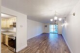 Located at 72 Nicholas Rd, Unit 10 in Framingham, MA, this one-bedroom, one-bathroom residence offers a well-designed, efficiently laid-out single-floor living space. Hardwood-style flooring flows consistently throughout, lending warmth and cohesion to every room.

The open living room is bright and airy, illuminated by natural light streaming through a sliding glass door that leads to a private balcony overlooking lush, tree-lined surroundings. A stylish chandelier and wall sconces provide warm ambient lighting, while a wall-mounted AC unit ensures year-round comfort. Baseboard heating is present throughout the unit.

The kitchen is thoughtfully appointed with light wood cabinetry, granite countertops, a classic tile backsplash, and a full suite of stainless steel appliances, including a refrigerator, range, and microwave. A flush-mount light fixture brightens the workspace.

The spacious primary bedroom offers generous closet space with two side-by-side closets and an additional door for easy access to the hallway. A window frames a natural wooded view, filling the room with soft, diffused light.

The bathroom features a clean, white tiled tub-shower combination, a vanity with sink, and wood-look flooring that complements the rest of the home. The entrance and hallway complete this thoughtfully organized layout, offering a welcoming and functional flow throughout.