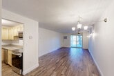 Located at 72 Nicholas Rd, Unit 10 in Framingham, MA, this one-bedroom, one-bathroom residence offers a well-designed, efficiently laid-out single-floor living space. Hardwood-style flooring flows consistently throughout, lending warmth and cohesion to every room.

The open living room is bright and airy, illuminated by natural light streaming through a sliding glass door that leads to a private balcony overlooking lush, tree-lined surroundings. A stylish chandelier and wall sconces provide warm ambient lighting, while a wall-mounted AC unit ensures year-round comfort. Baseboard heating is present throughout the unit.

The kitchen is thoughtfully appointed with light wood cabinetry, granite countertops, a classic tile backsplash, and a full suite of stainless steel appliances, including a refrigerator, range, and microwave. A flush-mount light fixture brightens the workspace.

The spacious primary bedroom offers generous closet space with two side-by-side closets and an additional door for easy access to the hallway. A window frames a natural wooded view, filling the room with soft, diffused light.

The bathroom features a clean, white tiled tub-shower combination, a vanity with sink, and wood-look flooring that complements the rest of the home. The entrance and hallway complete this thoughtfully organized layout, offering a welcoming and functional flow throughout.