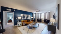 Located at 3940 W Broward Blvd in Plantation, Florida, this single-floor residence showcases a bold, contemporary design defined by rich navy blue accent walls, warm wood-look flooring, and a cohesive modern aesthetic throughout. The open-concept living area is anchored by a striking navy feature wall, a ceiling fan, and multiple windows that invite generous natural light, creating a bright and welcoming atmosphere. Adjacent to the living space, the dining area and kitchen flow seamlessly together. The kitchen is outfitted with white cabinetry, light quartz countertops, stainless steel appliances, and a central island with bar seating — ideal for both casual dining and entertaining. A dedicated laundry area is conveniently accessible from the kitchen corridor. The bedrooms are thoughtfully designed, each featuring bold accent walls, plush carpeting, and ample natural light from well-placed windows. The bathrooms are finished with tile flooring, white vanities with quartz counters, and full tub-shower combinations. A corner seating nook with wrap-around windows offers a bright, versatile retreat within the living space. Throughout, the residence balances modern sophistication with comfort, presenting a well-designed home in the heart of Plantation, FL.