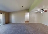 Located at 2800 N Tracy Blvd in Tracy, California, this single-level, one-bedroom, one-bathroom residence offers a thoughtfully laid-out floor plan across a compact yet efficient footprint. The living room is the heart of the home, featuring vaulted ceilings that lend a sense of openness, plush carpeting, a ceiling fan, and a tiled fireplace that serves as a focal point. A sliding glass door opens directly to a private balcony, inviting natural light and outdoor views into the space. The galley-style kitchen is efficiently designed with warm wood cabinetry, ample counter space, tile flooring, and white appliances including a gas range and dishwasher. A window above the sink provides natural light and ventilation. The bedroom is generously sized with soft carpet, vaulted ceilings, and access to a dedicated closet equipped with built-in shelving and dual hanging rods for organized storage. The full bathroom features tile flooring, a tub-shower combination, a wood-trimmed vanity with a single sink, and a large mirror. A hallway connects the rooms, contributing to a smooth and functional flow throughout the residence.