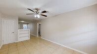 Located at 3603 Alice Street in Houston, TX, this single-floor, 2-bedroom, 1-bathroom residence offers a practical and comfortable layout. The combined kitchen and living area serves as the heart of the home, where the kitchen features white cabinetry, light countertops, a stainless steel sink, and black appliances including a gas range and refrigerator, all set on light-toned tile flooring. The living room flows naturally from the kitchen, highlighted by a ceiling fan with light fixture, built-in shelving, and access to natural light through a front-facing window.

Both bedrooms are finished with light wood-tone laminate flooring and are equipped with ceiling fans. The primary bedroom benefits from multiple windows that allow generous natural light and offer views of surrounding greenery. The second bedroom also features a paneled white door and connects to the main hallway via tile flooring.

The hallway links all areas of the home, including a dedicated closet for additional storage. The single full bathroom includes a tiled tub and shower combination with a window above, alongside a white vanity and toilet. Neutral tones and clean finishes throughout give the space a bright, move-in-ready feel.
