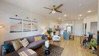 This well-designed one-bedroom, one-bathroom unit in Slidell, Louisiana offers a thoughtfully planned open-concept layout that seamlessly connects the living, dining, and kitchen areas. Light wood-tone flooring runs throughout the main living spaces, complementing the bright, neutral palette that defines the interior. A ceiling fan with integrated lighting anchors the living room, which benefits from recessed lighting and a relaxed, modern ambiance.

The kitchen is a standout feature, showcasing white shaker-style cabinetry, granite countertops, and a classic subway tile backsplash. A central island with pendant lighting provides additional prep space and casual seating, while stainless steel appliances — including a range, over-the-range microwave, and refrigerator — complete the space. A sliding glass door in the living area allows natural light to pour in and provides outdoor access.

The bedroom is a comfortable retreat, carpeted for warmth, with a ceiling fan, a large window with natural light, and ample room for furnishings. The bathroom is well-appointed with a granite-topped double vanity, white cabinetry, and wood-look flooring, leading directly to a spacious walk-in closet with built-in shelving. This unit offers a clean, contemporary feel throughout.
