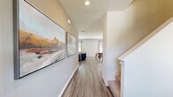 Located at 3442 Wages Way in Dacula, Georgia, this well-appointed two-story home offers four bedrooms and three bathrooms across two thoughtfully designed floors. The main level provides a generous living area with wood-look flooring, neutral tones, and a ceiling fan, creating a comfortable, relaxed atmosphere. The kitchen is a standout feature, showcasing white shaker cabinetry, stainless steel appliances, and a granite-topped island with seating for three — ideal for casual dining or entertaining. Adjacent to the kitchen, the dining room benefits from natural light through French doors that overlook the backyard, complemented by the same light hardwood-style flooring. A half bath on the main level adds convenience for guests. Upstairs, the primary bedroom is a spacious retreat with plush carpet, a ceiling fan, large windows with outdoor views, and direct access to a walk-in closet featuring wire shelving and carpeted floors. The additional bedrooms are well-sized with carpet and ample natural light. The upstairs laundry room includes side-by-side LG washer and dryer units with overhead wire shelving. Bathrooms feature clean white vanities and tub-shower combinations. The exterior includes a sizable fenced backyard with a patio, offering privacy and open green space.