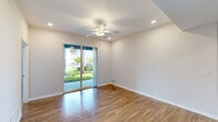 Located at 1730 Savona Point Circle in Cape Coral, Florida, this well-appointed 2-bedroom, 2-bathroom residence offers a thoughtfully designed single-level floor plan. The kitchen is a standout feature, showcasing an expansive granite island with a double undermount sink, rich dark cabinetry, a white subway tile backsplash, stainless steel appliances, and elegant pendant lighting above a tray ceiling — creating a sleek, functional space ideal for cooking and entertaining.

The open layout flows into a bright living area with wood-style flooring, recessed lighting, a ceiling fan, and sliding glass doors that invite natural light and outdoor views of the lush, palm-lined surroundings. Both bedrooms are carpeted and feature tray ceilings, dedicated closets, and direct access to their respective bathrooms. The primary bathroom is outfitted with a granite vanity, dark cabinetry, a large mirror, and a glass-enclosed shower. The secondary bathroom includes a full tub-shower combination with classic white tile.

Additional highlights include a dedicated in-unit laundry room with a full-size washer and dryer, two closets for ample storage, and a covered front entry framed by tropical palms and manicured greenery — capturing the essence of Florida living.