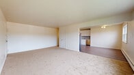 Located at 644 Silver Lake Scotchtown Rd in Middletown, NY, this single-floor, 2-bedroom, 1-bathroom residence offers a well-organized layout designed for comfortable everyday living. The open living room is generously sized, featuring plush wall-to-wall carpeting, neutral tones, and large windows that fill the space with natural light while offering views of the surrounding neighborhood. A ceiling fan adds both function and character to the room. The updated kitchen is a standout feature, showcasing white shaker-style cabinetry, granite-look countertops, a subway tile backsplash, and a full suite of stainless steel appliances including a gas range, microwave, dishwasher, and refrigerator. Light wood-style flooring runs throughout the kitchen, lending a clean, modern feel. The primary bedroom is notably spacious, with carpet flooring, baseboard heating, a wall-mounted AC unit, and bright windows. The second bedroom also features carpet, natural light, and baseboard heating. The full bathroom is neatly appointed with white subway tile surrounding the tub/shower combo, a white vanity, and tile flooring. Six closets throughout the unit provide exceptional storage, while a hallway connects the living areas efficiently.