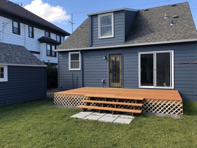 Back deck is shared between both units and will have a divider (not shown) installed to create privacy and separation. Grass back yard with garden is shared. - 4842 NE Mallory Ave