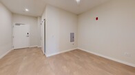 This contemporary 670 square foot apartment, located at 250 College Avenue in Lancaster, PA, offers a blend of style and functionality. The heart of the home is the modern kitchen, featuring crisp white cabinetry, stainless steel appliances, and quartz countertops. Oversized glass pendant lights add a touch of elegance, while a subway tile backsplash completes the refined look.

The bathroom continues the modern aesthetic with a floating vanity, large mirror, and ample lighting. Light-colored tile flooring enhances the sense of space and cleanliness. Throughout the apartment, neutral tones and clean lines create a serene atmosphere.

The layout is efficiently designed, with two hallways providing easy access to all areas. A closet offers additional storage space. The apartment's single floor plan maximizes the use of its 670 square feet, creating a spacious feel despite its compact size.

Large windows allow natural light to flood the space, while recessed lighting provides additional illumination. The light wood flooring throughout adds warmth and continuity to the design. This apartment combines contemporary style with practical living, perfect for those seeking a modern urban lifestyle in Lancaster.