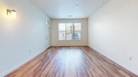Located in Parker, CO, this well-appointed 2-bedroom, 2-bathroom residence offers a thoughtfully designed single-level layout. Rich hardwood-style flooring flows throughout the main living areas, creating a warm and cohesive aesthetic. The open kitchen serves as a central hub, featuring warm wood cabinetry, granite countertops with a peninsula island and sink, and a full suite of stainless steel appliances including a range, microwave, and refrigerator. Adjacent to the kitchen, a dedicated laundry closet houses a stacked washer and dryer for added convenience. The living room is bright and airy, with large windows that invite natural light and a ceiling fan overhead, and opens to a front entry door with a transom window above. Both bedrooms are carpeted for comfort — one features a double-door closet, while the other offers a window view to the outside. Three closets throughout the unit provide ample storage. The two bathrooms each feature granite-topped wood vanities and hardwood-style flooring; one includes a soaking tub with tiled surround, and the other a tiled walk-in shower, both equipped with accessibility grab bars.