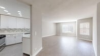 Located at 7918 Reseda Blvd in the Reseda neighborhood of Los Angeles, this single-floor unit offers a clean, modern aesthetic with an open-concept design that promotes seamless flow between living spaces. Light gray luxury vinyl plank flooring runs throughout the main areas, complementing the neutral wall tones and crisp white trim to create a bright, cohesive atmosphere.

The kitchen is a standout feature, showcasing white shaker-style cabinetry with brushed nickel hardware, light quartz countertops, and a decorative mosaic tile backsplash in gray and white tones. Stainless steel and black appliances—including a gas range, microwave, refrigerator, and dishwasher—are all included. A peninsula counter opens the kitchen to the living area, enhancing the sense of space and encouraging easy entertaining.

The spacious living area benefits from a large window that allows natural light to pour in, keeping the space feeling open and airy. The bedroom features plush carpeting and a closet, providing a comfortable retreat.

The bathrooms are finished with white vanity cabinetry, light stone-look countertops, large mirrors, and matching vinyl plank flooring, maintaining the unit's consistent modern style. Recessed lighting in the kitchen and smooth ceilings with textured accents in the living area add further detail to this well-appointed space.