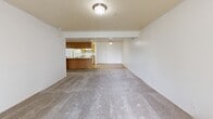 This one-bedroom, one-bathroom unit in Riverton, Utah offers a functional and well-organized single-floor layout. The open-concept kitchen and living area forms the heart of the space, where light maple cabinetry, a peninsula with a double sink, white appliances including a refrigerator and electric range, and tile flooring define the kitchen zone. Upper cabinets provide ample storage, and the peninsula creates a natural transition into the carpeted living room. The living room is spacious and bright, featuring a sliding glass door that opens to an outdoor balcony, allowing natural light to fill the area and providing outdoor views.

The bedroom is a comfortable, well-proportioned room with carpet flooring, a window overlooking the exterior, and access to a dedicated closet. The full bathroom is appointed with a light maple vanity offering generous under-sink storage, a large wall mirror with overhead lighting, tile flooring matching the kitchen, and a full-size tub and shower combination. A separate utility room provides additional functional space within the unit. Throughout, the neutral white walls, consistent flooring materials, and straightforward layout create a clean, practical living environment suited for everyday comfort.