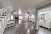 Located at 4020 Versailles Blvd in Oklahoma City, Oklahoma, this two-story home offers four bedrooms and four bathrooms across two well-proportioned floors. The main level sets the tone with a generous layout, featuring dark hardwood flooring throughout the living areas and a standout brick fireplace that anchors the living room. Crown molding and ceiling fans add classic character, while recessed lighting provides a clean, modern touch. The kitchen is equipped with white cabinetry, granite countertops, a stainless steel dishwasher, and French doors that open to the outside, allowing natural light to fill the space. A wet bar area with white cabinetry provides additional functionality on the main level. A tiled hallway connects key areas of the lower floor, leading to a carpeted staircase that ascends to the upper level. The upper floor houses the spacious primary bedroom — notably generous in size — along with additional bedrooms, each featuring hardwood floors, ceiling fans, and natural light from windows with blinds. The four bathrooms include clean, tile-surround showers and updated vanities with stone countertops. A dedicated laundry room and multiple closets throughout the home add practical storage solutions to this well-rounded Oklahoma City residence.