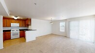 Located on Saticoy Street in the Winnetka neighborhood of Los Angeles, this single-floor, 2-bedroom, 1-bathroom unit offers a practical and comfortable layout. The open-concept living and dining area is spacious and bright, featuring wall-to-wall carpet, a pendant light fixture, and large windows and a sliding glass door with vertical blinds that let in generous natural light. The kitchen is well-equipped with rich warm-toned wood cabinetry, dark granite countertops, a gas range, built-in microwave, dishwasher, and a double sink, all set on light tile flooring. A peninsula counter connects the kitchen to the living area, enhancing the open flow. Both bedrooms are carpeted and maintain a clean, neutral palette. The primary bedroom includes a sliding glass door to an outdoor area and a closet, while the secondary bedroom features a window with exterior views and a sliding-door closet. The full bathroom is finished with large earth-toned ceramic wall tiles surrounding the soaking tub and shower combination, complemented by tile flooring. Throughout the unit, the consistent use of neutral tones and natural light creates a calm, functional living environment.