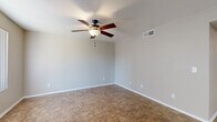 Located at 2445 W Glenrosa Ave in Phoenix, Arizona, this single-story, 2-bedroom, 1-bathroom home offers a practical and comfortable layout. The living room is bright and open, featuring tile flooring, a ceiling fan with light fixture, and vertical blinds that allow for natural light control. It connects seamlessly to the combined kitchen and dining area, making the space feel cohesive and functional. The kitchen is well-appointed with dark espresso cabinetry, granite-look countertops, a full suite of black appliances including a refrigerator, electric range, built-in microwave, and dishwasher, all set on matching tile flooring. Both bedrooms are generously sized, each equipped with ceiling fans, tile flooring, and windows with vertical blinds for natural light. The primary bedroom offers a comfortable footprint suitable for a full furniture arrangement. Three closets distributed throughout the home provide ample storage. The bathroom includes a full tub-shower combination with white tile surround. Neutral-toned walls and consistent tile flooring throughout give the home a clean, uniform aesthetic. A hallway connects the main living areas to the private bedrooms, ensuring a well-organized flow throughout the residence.