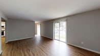Located at 3051 Kirklevington Dr in Lexington, KY, this two-floor home offers a well-designed layout with modern updates throughout. The main level features open living areas adorned with durable hardwood-style flooring and neutral gray walls, creating a clean, contemporary aesthetic. Sliding glass doors in the living room flood the space with natural light and provide direct access to an outdoor area, offering pleasant views of the surrounding greenery. A half bathroom on the main level adds everyday convenience.

The kitchen is thoughtfully appointed with crisp white cabinetry, marble-style countertops, a classic subway tile backsplash, and a full suite of stainless steel appliances including a refrigerator, electric range, and over-the-range microwave. The hardwood-style flooring continues seamlessly through the kitchen, reinforcing the cohesive design.

A carpeted staircase leads to the upper level, where the bedrooms are finished with plush carpet for added comfort. Bedrooms feature louvered bifold closet doors with generous built-in storage. The upper-level bathroom is outfitted with wood-look flooring, white vanity cabinetry, and a clean, functional layout. Throughout both floors, the neutral color palette, consistent finishes, and thoughtful details combine to create a comfortable and practical living environment.