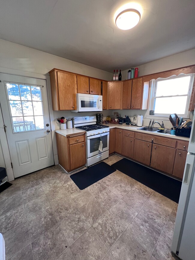 Kitchen with new microwave and stove. - 1031 14th Ave SE