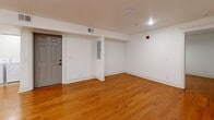 Located at 806 E Chestnut St in Louisville, KY, this well-appointed one-bedroom, one-bathroom unit offers a thoughtfully designed single-floor layout. Warm hardwood flooring flows throughout the living areas and bedroom, creating a cohesive and inviting atmosphere. The open kitchen and living room combination is anchored by a modern kitchen featuring white shaker cabinetry, granite countertops, a classic subway tile backsplash, and a full suite of stainless steel appliances including a range, microwave, and dishwasher. The spacious bedroom is fitted with a ceiling fan, natural light from a window, and a dedicated closet with built-in shelving. The bathroom is a standout feature, finished with floor-to-ceiling marble-style tile, a soaking tub with a rain showerhead, matte black fixtures, a white vanity, and a large mirror. A dedicated laundry room with a full-size washer and dryer adds everyday convenience. Clean white walls, recessed lighting, and crisp trim work throughout lend the space a fresh, modern feel that is both functional and comfortable.