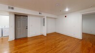 Located at 806 E Chestnut St in Louisville, KY, this well-appointed one-bedroom, one-bathroom unit offers a thoughtfully designed single-floor layout. Warm hardwood flooring flows throughout the living areas and bedroom, creating a cohesive and inviting atmosphere. The open kitchen and living room combination is anchored by a modern kitchen featuring white shaker cabinetry, granite countertops, a classic subway tile backsplash, and a full suite of stainless steel appliances including a range, microwave, and dishwasher. The spacious bedroom is fitted with a ceiling fan, natural light from a window, and a dedicated closet with built-in shelving. The bathroom is a standout feature, finished with floor-to-ceiling marble-style tile, a soaking tub with a rain showerhead, matte black fixtures, a white vanity, and a large mirror. A dedicated laundry room with a full-size washer and dryer adds everyday convenience. Clean white walls, recessed lighting, and crisp trim work throughout lend the space a fresh, modern feel that is both functional and comfortable.