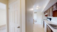 Located at 4363 Chestnut Ridge Rd in Buffalo, NY, this one-bedroom, one-bathroom unit offers a practical and comfortable single-floor layout. The combined kitchen and living area serves as the heart of the home, with the kitchen featuring warm wood cabinetry, white countertops, tile flooring, and white appliances including a refrigerator, electric range, and dishwasher. A built-in breakfast bar adds a convenient dining option. The living room is carpeted and bathed in natural light, with a sliding glass door that opens to a private balcony, bringing in an airy, open feel. The bedroom is a well-sized retreat with plush carpet flooring, two closet doors offering ample storage, and a window that invites natural light throughout the day. The full bathroom is clean and functional, featuring a tub and shower combination with a curtain rod, tile flooring, and neutral wall tones that contribute to a bright, fresh atmosphere. A hallway connects the rooms efficiently, completing this well-organized floor plan. The space is finished in a neutral color palette throughout, creating a versatile backdrop that is easy to personalize.