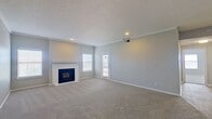 This spacious apartment offers a blend of comfort and contemporary design. The open-concept living area showcases a striking fireplace as its focal point, complemented by large windows that flood the space with natural light. The kitchen boasts modern appliances, sleek countertops, and ample cabinet space. Two generously-sized bedrooms feature plush carpeting and ceiling fans. The bathroom is efficiently designed with updated fixtures and a combination tub/shower. Throughout the apartment, neutral tones create a calm ambiance, while recessed lighting and crown molding add refined touches. The layout maximizes space utilization, making it ideal for both relaxation and entertaining.