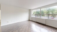 Located at 4981 Bathurst Street in Toronto's North York neighbourhood, this one-bedroom unit offers a thoughtfully arranged single-floor layout comprising a kitchen, bedroom, and hallway. The renovated kitchen is a standout feature, outfitted with crisp white cabinetry, a classic subway tile backsplash, and a full suite of stainless steel appliances including a refrigerator, electric range, and built-in microwave. Light tile flooring in the kitchen transitions seamlessly into warm parquet wood flooring that extends throughout the living and bedroom areas, adding a timeless character to the interior. The living area is bright and open, benefiting from a large picture window that frames lush green tree views and allows generous natural light to fill the space. The bedroom is a well-proportioned private retreat, also featuring parquet flooring, a window overlooking greenery, and a built-in sliding door closet for ample storage. Crisp white walls throughout create a clean, neutral backdrop, while a wall-mounted radiator system provides consistent heating. The hallway connects the rooms efficiently, completing this functional and well-presented urban residence.