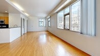 Located in the heart of Downtown Los Angeles on South Main Street, this one-bedroom, one-bathroom unit offers a well-designed layout with modern finishes throughout. Warm bamboo hardwood floors extend across the living areas and spacious bedroom, creating a cohesive and inviting atmosphere.

The kitchen is efficiently appointed with a full suite of stainless steel appliances, including a gas range, over-the-range microwave, dishwasher, and refrigerator. Rich wood cabinetry pairs with dark granite-style countertops and a dark tile backsplash, lending a contemporary feel to the space. A window above the sink provides natural light to the cooking area.

The generously sized bedroom features multiple windows that frame views of the surrounding Downtown Los Angeles cityscape, filling the room with natural light. Clean white walls and polished floors contribute to an open, airy feel.

The bathroom is finished with light tile flooring, a tiled shower-tub combination, a wall-mounted vanity with wood cabinetry, and recessed lighting. Additional conveniences include an in-unit laundry area and a dedicated closet. A clean entryway with thermostat controls and a frosted-glass entry door completes this functional urban residence.