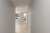 This one-bedroom, one-bathroom unit at 211 Hawthorne Ave in Central Islip, NY offers a well-designed layout with a thoughtful use of space across its single floor. Light wood-style flooring and a neutral gray-and-white color palette run throughout, lending a clean, cohesive look to every room.

A welcoming hallway connects the main areas of the unit, lined with multiple closets — four in total — providing exceptional storage rarely found in similarly sized homes. The hallway opens into a combined kitchen and living area that forms the heart of the unit. The kitchen is a standout feature, showcasing rich dark-toned shaker cabinets, white quartz countertops, a striking marble-style tile backsplash, and a full suite of stainless steel appliances including a gas range, microwave, dishwasher, and refrigerator. A peninsula with matching cabinetry provides additional counter space and separates the kitchen from the open living area, which benefits from multiple windows that invite natural light and offer views of surrounding greenery.

The generously sized bedroom features two access points, a wall-unit air conditioner, and baseboard heating, ensuring year-round comfort. Natural light filters in through a window with views of the outdoors. The unit combines modern finishes with practical functionality, making it a well-appointed home in Central Islip.