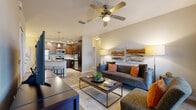 Located at 10207 Dwell Court in Orlando, FL, this single-floor, 2-bedroom, 2-bathroom residence offers a thoughtfully designed open-concept layout. Wood-look flooring flows throughout the main living areas, connecting the kitchen, dining nook, and living room seamlessly. The kitchen is a standout feature, showcasing rich dark-wood cabinetry that extends to the ceiling, granite countertops, stainless steel appliances, track lighting, and a peninsula island with bar seating — ideal for casual dining or entertaining. The living room is bright and welcoming, with a ceiling fan overhead and a sliding glass door that opens to a private outdoor area with views of lush greenery and palm trees. Both bedrooms are carpeted for comfort. The spacious primary bedroom features large windows that invite abundant natural light and garden views. Each bedroom includes a dedicated closet with built-in shelving. The bathrooms are finished with granite vanities, dark wood cabinetry, and tile flooring, with one featuring a shower-tub combination. A dedicated in-unit laundry room with a full-size washer and dryer adds everyday convenience. The overall ambiance is modern, warm, and functional throughout.