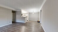 Located in Murfreesboro, TN, this well-appointed 2-bedroom, 3-bathroom single-floor home offers a thoughtfully designed layout with a clean, modern aesthetic throughout. The open-concept living and dining area is anchored by hardwood-style flooring, crown molding, and a pendant light fixture, creating a bright and welcoming atmosphere. A bank of windows with a ceiling fan fills the space with natural light and connects seamlessly to the entry.

The kitchen features white cabinetry, light countertops, stainless steel appliances, and a peninsula that opens to the living area — ideal for both everyday living and entertaining. An in-unit laundry area with a full-size washer and dryer adds everyday convenience.

The spacious primary bedroom is a standout, boasting a bay window configuration that floods the room with natural light, hardwood-style flooring, crown molding, and a ceiling fan. The second bedroom offers plush carpeting and a bright window. Both bedrooms include closet access, and the three bathrooms are finished with clean, neutral tones, white vanities, and hardwood-style flooring. Two hallways provide efficient flow throughout the home, completing a functional and comfortable floor plan.