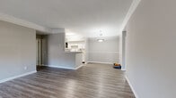 Located in Murfreesboro, TN, this well-appointed 2-bedroom, 3-bathroom single-floor home offers a thoughtfully designed layout with a clean, modern aesthetic throughout. The open-concept living and dining area is anchored by hardwood-style flooring, crown molding, and a pendant light fixture, creating a bright and welcoming atmosphere. A bank of windows with a ceiling fan fills the space with natural light and connects seamlessly to the entry.

The kitchen features white cabinetry, light countertops, stainless steel appliances, and a peninsula that opens to the living area — ideal for both everyday living and entertaining. An in-unit laundry area with a full-size washer and dryer adds everyday convenience.

The spacious primary bedroom is a standout, boasting a bay window configuration that floods the room with natural light, hardwood-style flooring, crown molding, and a ceiling fan. The second bedroom offers plush carpeting and a bright window. Both bedrooms include closet access, and the three bathrooms are finished with clean, neutral tones, white vanities, and hardwood-style flooring. Two hallways provide efficient flow throughout the home, completing a functional and comfortable floor plan.