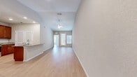 Located at 2796 Spring Orchard Ave in the charming city of Mt Dora, Florida, this single-floor residence offers a bright and welcoming interior designed for comfortable everyday living. The open living area immediately impresses with its vaulted ceiling, ceiling fan, and light wood-look flooring that extends throughout the home, creating a clean and cohesive aesthetic. Natural light filters in through front-facing windows and a glass-paneled entry door, enhancing the airy feel of the space.

The kitchen is a functional highlight, outfitted with rich warm-toned cabinetry, granite countertops, a herringbone-patterned tile backsplash, and a full suite of stainless steel appliances including a refrigerator, range, and built-in microwave. Ample upper and lower cabinet storage ensures generous space for kitchen essentials.

The bedrooms are generously sized, each featuring ceiling fans, windows with vertical blinds for natural light control, and closets with built-in shelving. One bedroom includes a mirrored sliding-door closet.

Both bathrooms continue the granite countertop theme, complemented by warm wood-toned vanity cabinetry. The primary bathroom features a dual-sink vanity and a glass-enclosed shower, while the secondary bathroom offers a full tub-shower combination with clean white tile surrounds. Light wood flooring ties all spaces together seamlessly.