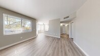 Located at 2750 W Wigwam Ave in Las Vegas, NV, this three-bedroom, two-bathroom single-floor residence offers a clean, modern aesthetic with a thoughtful layout. The open-concept living and dining area is bright and airy, featuring light-toned wood-look flooring and neutral warm-gray walls that carry consistently throughout the home. Large windows with blinds allow generous natural light to fill the space, creating a welcoming atmosphere.

The kitchen is well-appointed with crisp white cabinetry, light quartz countertops, stainless steel appliances including a gas range and over-the-range microwave, and a ceiling fan overhead. A peninsula provides additional counter space and casual seating options, while a dedicated window keeps the area bright.

The primary bedroom is a comfortable size and is highlighted by a distinctive bay window that floods the room with natural light. It includes a closet and direct access to a bathroom. The two additional bedrooms are well-proportioned with their own closets and share a clean, functional bathroom featuring a tub-shower combination and a white vanity.

Each bathroom is finished with wood-look flooring, white fixtures, and light stone-topped vanities. The three closets, including a spacious walk-in style with wire shelving, offer ample storage. The home's cohesive neutral palette and consistent finishes give it a fresh, move-in-ready feel.
