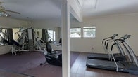 This single-floor fitness space is thoughtfully designed to support a well-rounded exercise routine. The room is divided into distinct functional zones, with a carpeted area housing strength training equipment — including a multi-station cable machine — and a tiled section dedicated to cardio machines such as treadmills. A large wall mirror spans one side of the space, creating a sense of openness while allowing users to monitor their form during workouts. Structural columns add architectural character to the room without interrupting the flow between zones. Natural light filters in generously through multiple windows, offering views of surrounding greenery and creating a bright, welcoming atmosphere. The neutral wall tones and clean finishes contribute to a calm, focused environment. The combination of practical flooring choices — soft carpet underfoot in the strength area and durable tile in the cardio zone — reflects an attention to both comfort and functionality. Overall, this fitness space delivers a complete and inviting environment for a variety of training activities.