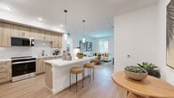 Located at 1151 Encanto Loop in Chula Vista, CA, this thoughtfully designed single-story home offers two bedrooms, two bathrooms, an office, and two closets across a well-utilized floor plan. The open-concept kitchen and living area serves as the heart of the home, featuring light wood cabinetry with black hardware, white quartz countertops, a stylish tile backsplash, stainless steel appliances, and a breakfast bar with pendant lighting. Light wood-look flooring flows throughout, enhancing the bright, airy atmosphere. The living room receives natural light through large windows and connects seamlessly to the kitchen and dining areas. The primary bedroom is a comfortable retreat highlighted by a textured accent wall, a ceiling fan, natural light from a large window, and direct access to a walk-in closet with built-in wire shelving. The second bedroom is equally well-appointed with natural light and wood-look flooring. Both bathrooms are clean and modern, with one featuring a full soaking tub and shower combination. A dedicated office provides flexible space for work or study. A private outdoor entry area with room for seating completes this well-rounded home.