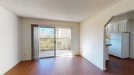 Located at 2050 Royal Dr in Santa Clara, California, this single-floor residence offers a practical and well-organized layout suited for comfortable everyday living. The main living area features warm wood-style flooring and is bathed in natural light through a large sliding glass door that opens directly onto a private balcony, offering outdoor views of the surrounding neighborhood. Baseboard heating runs along the walls, ensuring consistent warmth throughout the space. The textured ceilings are consistent throughout the unit, adding a classic residential character.

The kitchen is efficiently designed with white cabinetry, granite-style countertops, a tile backsplash, a stainless steel sink, and a white electric range. A window above the sink brings in additional natural light, making the space bright and functional.

The bedrooms are carpeted for comfort and each features sliding mirrored closet doors that enhance the sense of space. One bedroom includes a sliding glass door providing direct balcony access and views of the exterior.

The bathroom is clean and straightforward, equipped with a full tub and shower combination, white tile surround, and wood-style flooring. The overall design throughout the residence is neutral and bright, creating a versatile canvas well-suited to a variety of living arrangements.